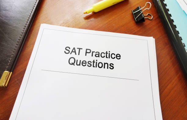 SAT Practice Questions study guide on a desk